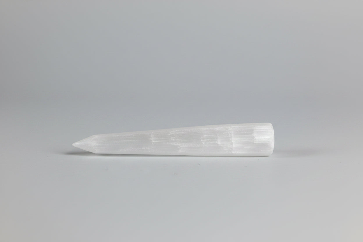 Clear stone tool on a gray background