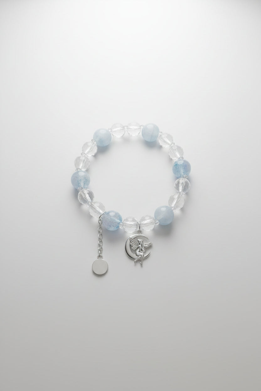 Bracelet with blue and clear beads on a gray surface