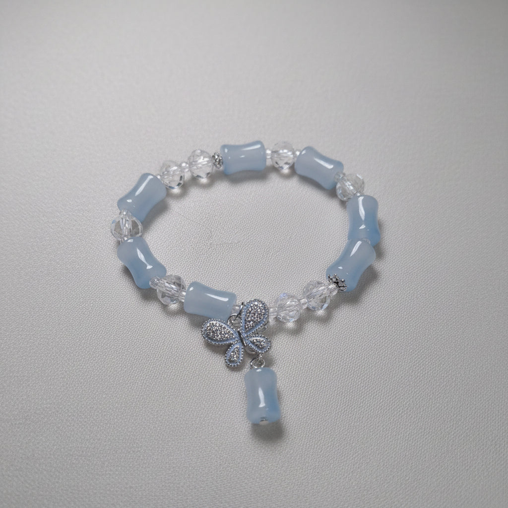Beaded bracelet with blue and clear beads on a gray background