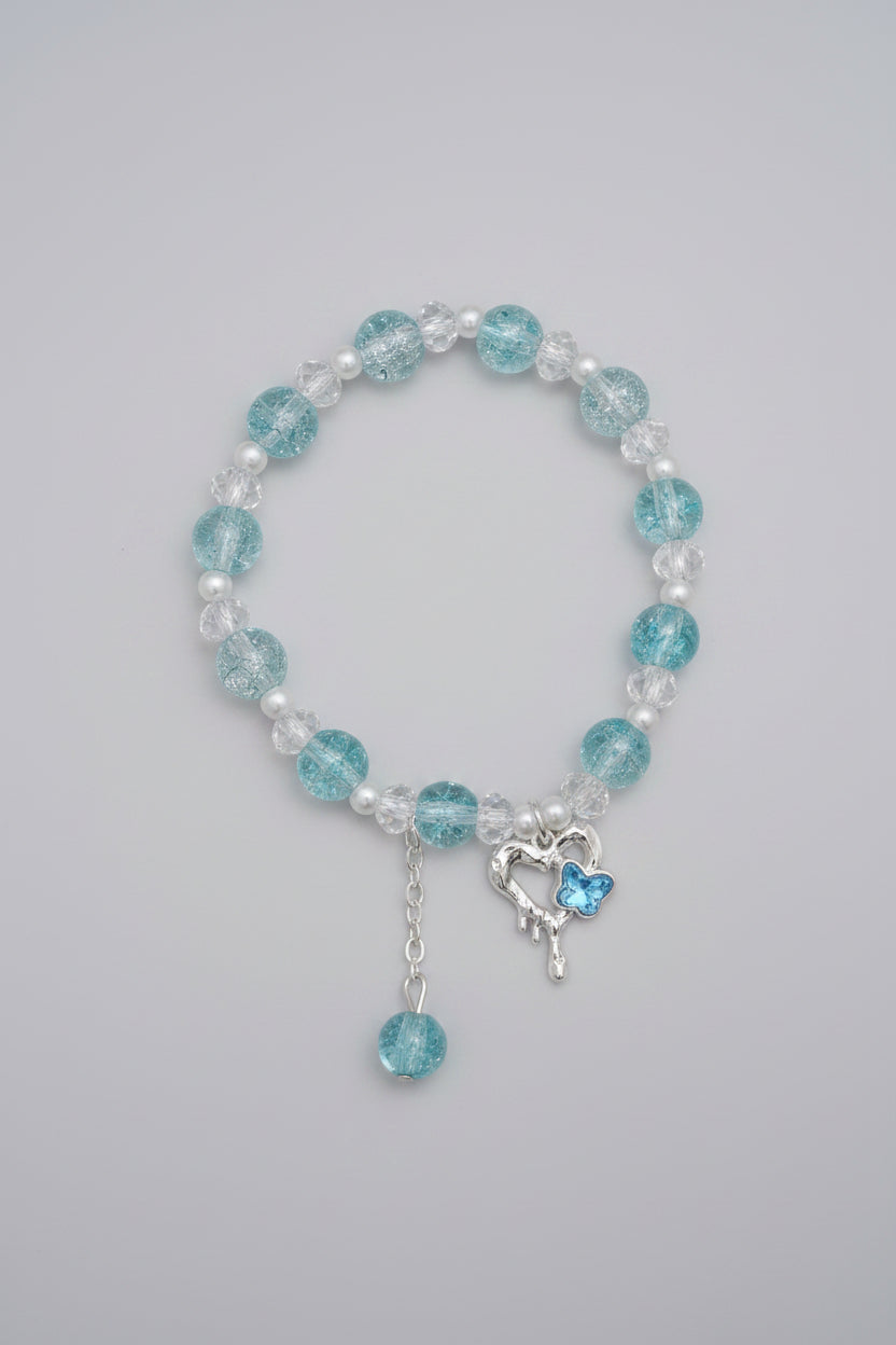 Bracelet with blue and clear beads on a light gray background