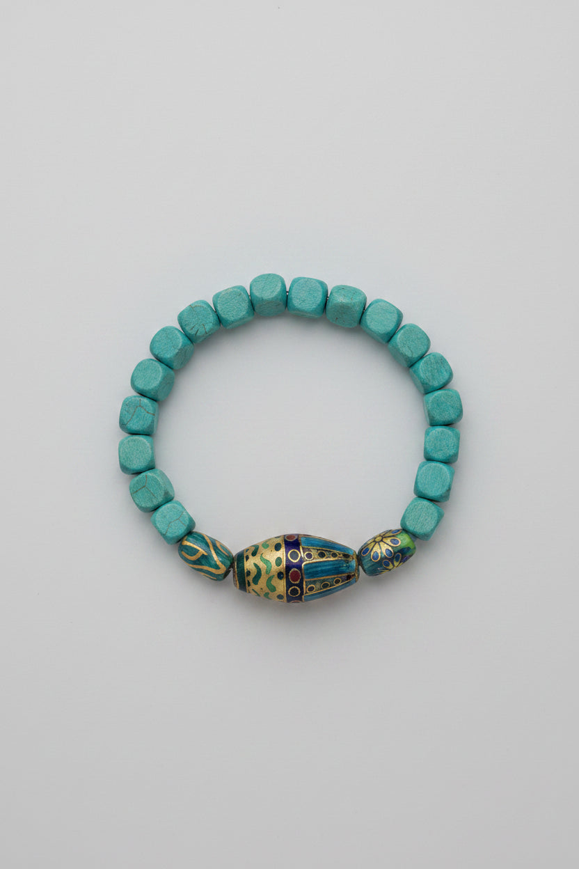 Beaded bracelet with blue beads on a gray fabric background