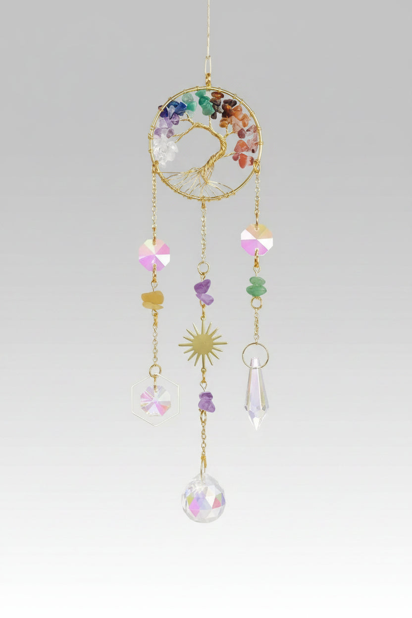 A hanging dreamcatcher-style ornament with colorful beads, a gold hoop, and translucent crystal-like drops, shown in a softly lit interior scene with light streaks and rainbow reflections. The photo appears to be a screenshot from a shopping app, with interface elements and a black background around the product.