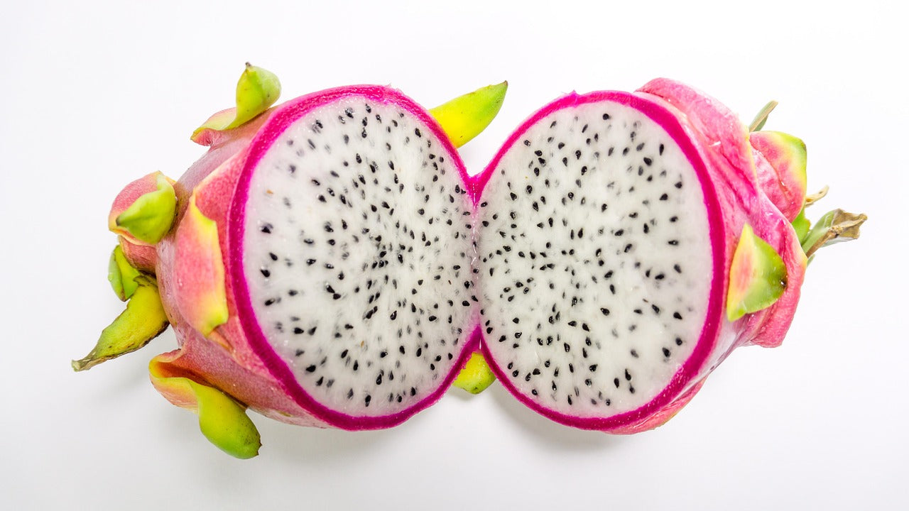 Halved dragon fruit on a white background