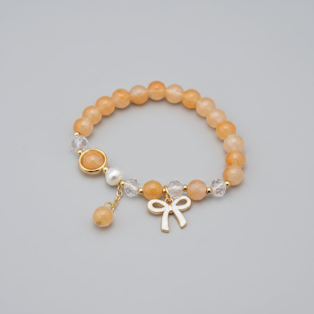Bracelet with beads and a charm on a textured surface
