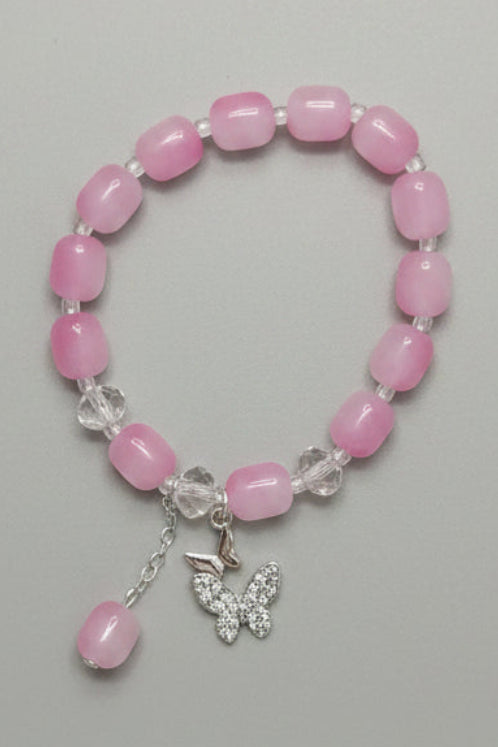Pink beaded bracelet with a silver clasp on a gray fabric background