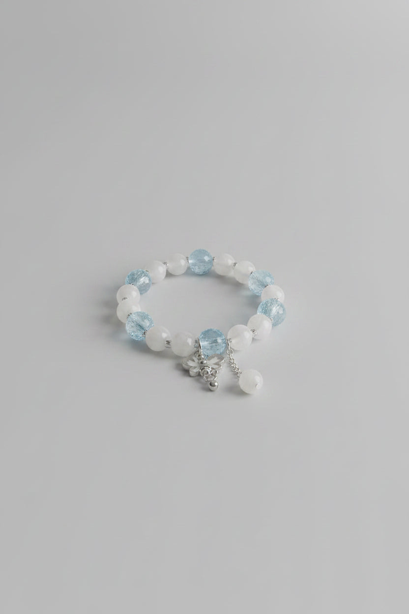 Bracelet with blue beads on a light gray background