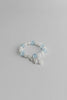 Bracelet with blue beads on a light gray background
