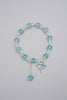 Bracelet with blue and clear beads on a light gray background