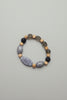 Bracelet made of natural stone beads on a grey surface