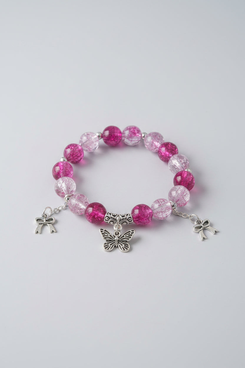 Bracelet with pink beads and butterfly charms on a light gray background