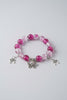 Bracelet with pink beads and butterfly charms on a light gray background