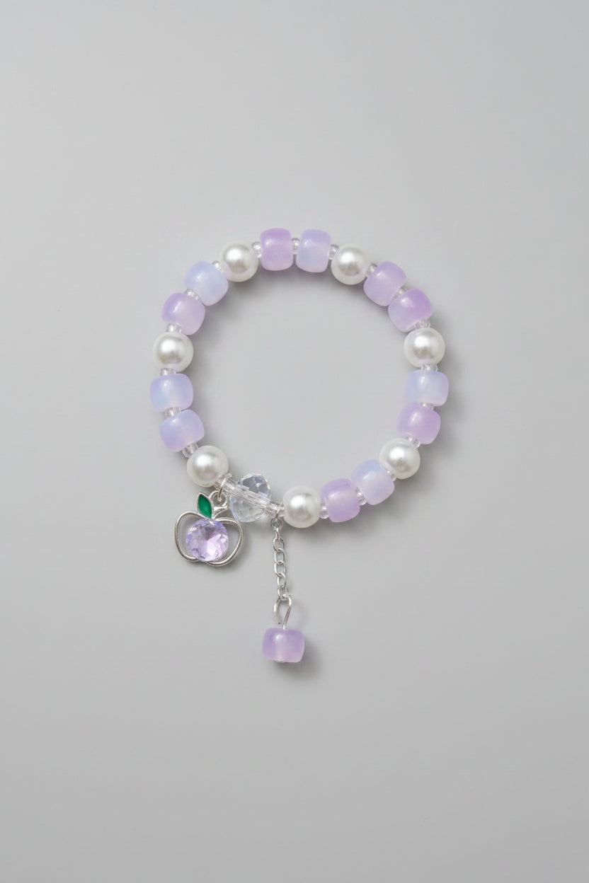 pink Beaded bracelet with charms on a gray background