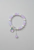 pink Beaded bracelet with charms on a gray background