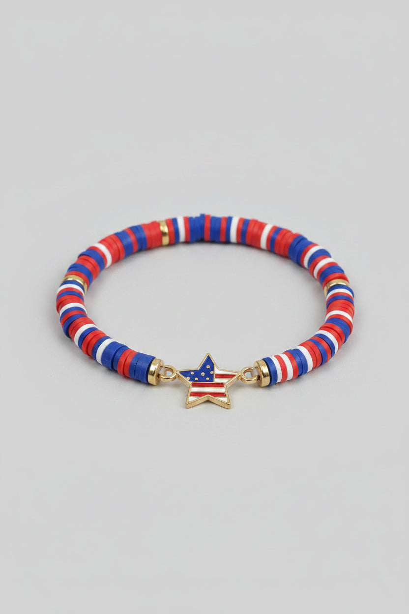 Bracelet with red, white, and blue beads on a wrist against a blurred background
